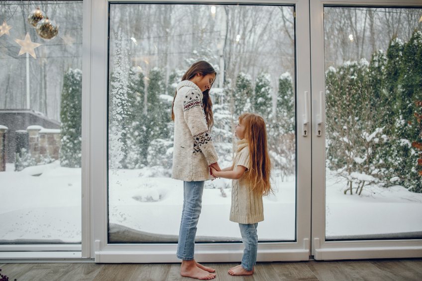 children in front of home window