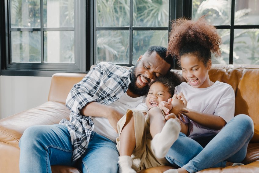 happy family on sofa near window